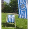 Custom beach chair with blue and white striped canvas on lawn near advertising flag