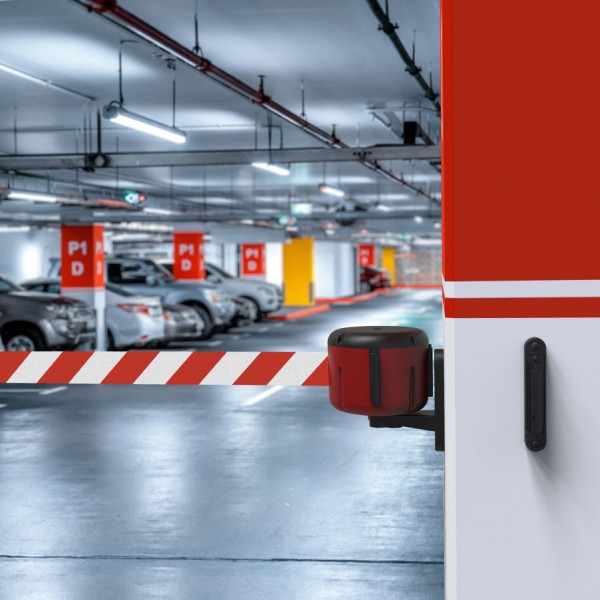 Wall-mounted retractable belt dispenser installed in car park