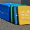 Custom cube seat blue, green, turquoise and yellow aligned outdoors