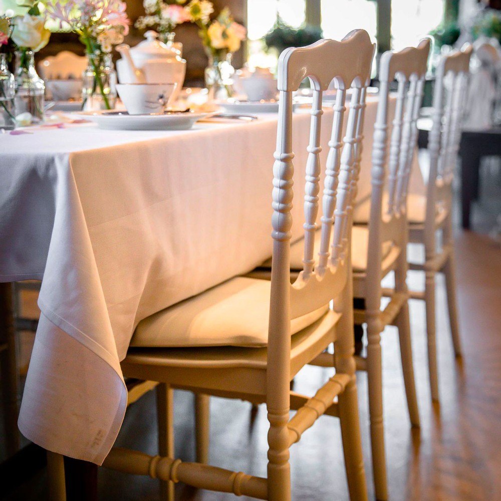 White traditional design chairs in reception setting