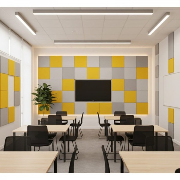 Des anneaux muraux acoustiques Quadra gris et jaunes habillent les murs d’une salle de classe contemporaine.