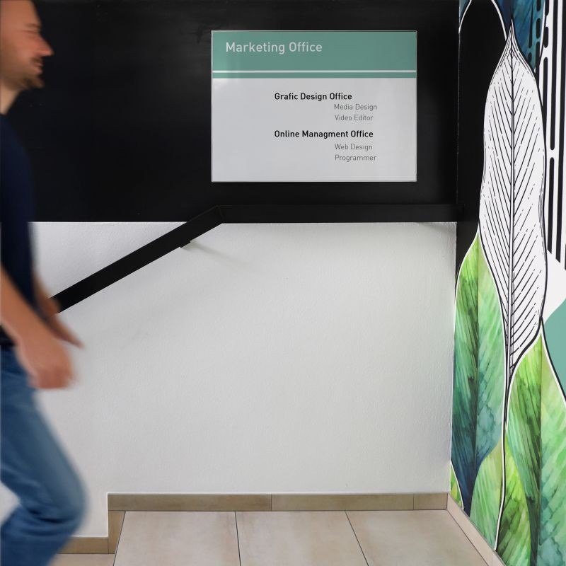 Signcode® Slim magnetic wall display panel mounted high with an office directory plate