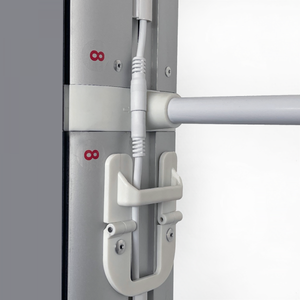 Power connector and cable retaining clip inside the illuminated frame