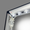 Corner of the aluminium frame with the LEDs lit along the inner profile