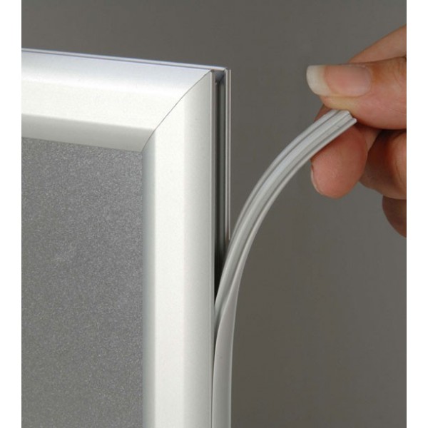 Slide-in poster frame, detail of profile gasket removed at frame corner for poster insertion